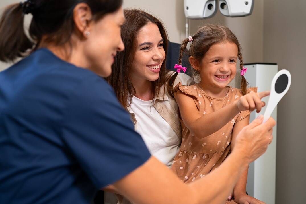 Girl smiling during a family dental checkup.